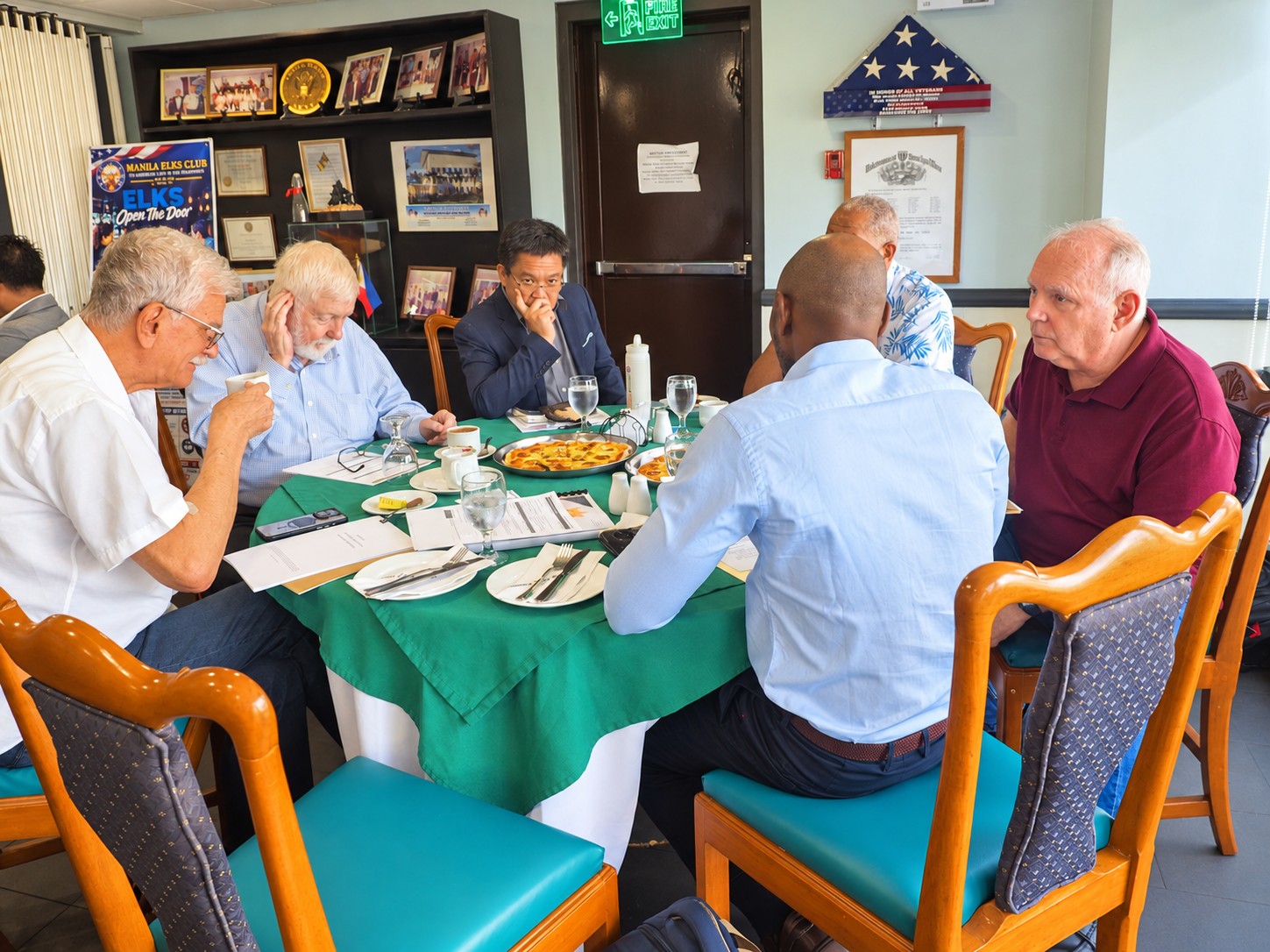 Participants in MitchelleFrankline Corp's inaugural board meeting engaged in discussion