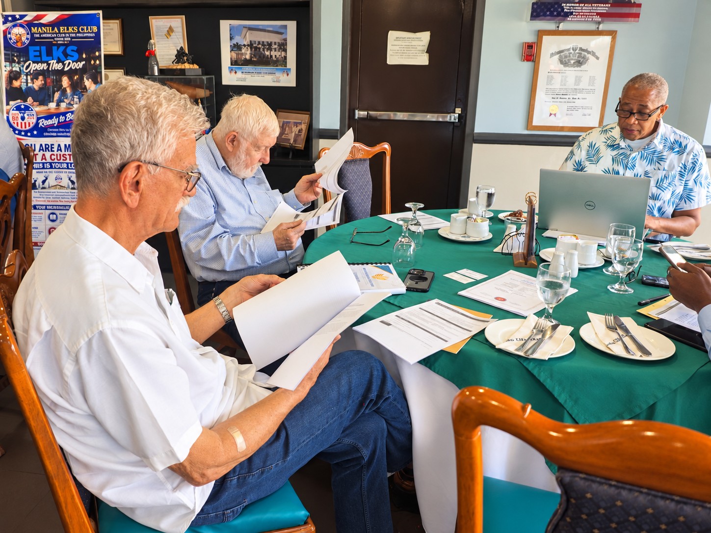 Meeting participants reviewing materials during MitchelleFrankline Corp's inaugural board meeting